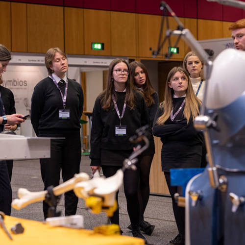 A group of students observe an exhibit at BHS Conference 2023
