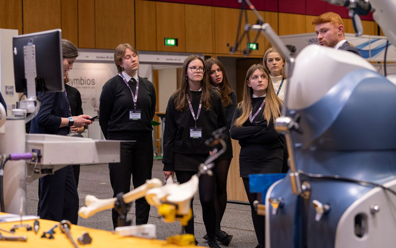 A group of students observe an exhibit at BHS Conference 2023