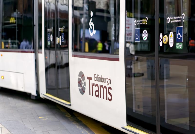 Image of the side of an edinburgh tram showing the wheelchair accessible sign on the window