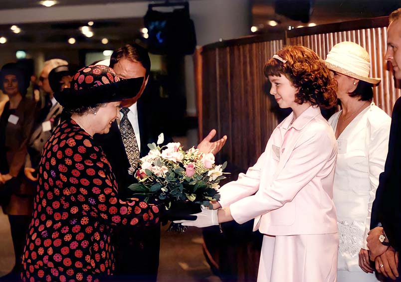 The Queen is presented with a bouquet at the EICC in 1996