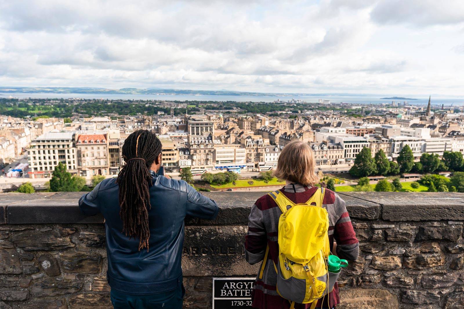 Two women look out over Edinburgh from the castle esplanade